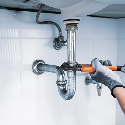 Hands under running shower water in Keller Texas home serviced by Polly Plumbing